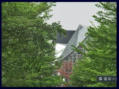 Opera seen behind the trees.